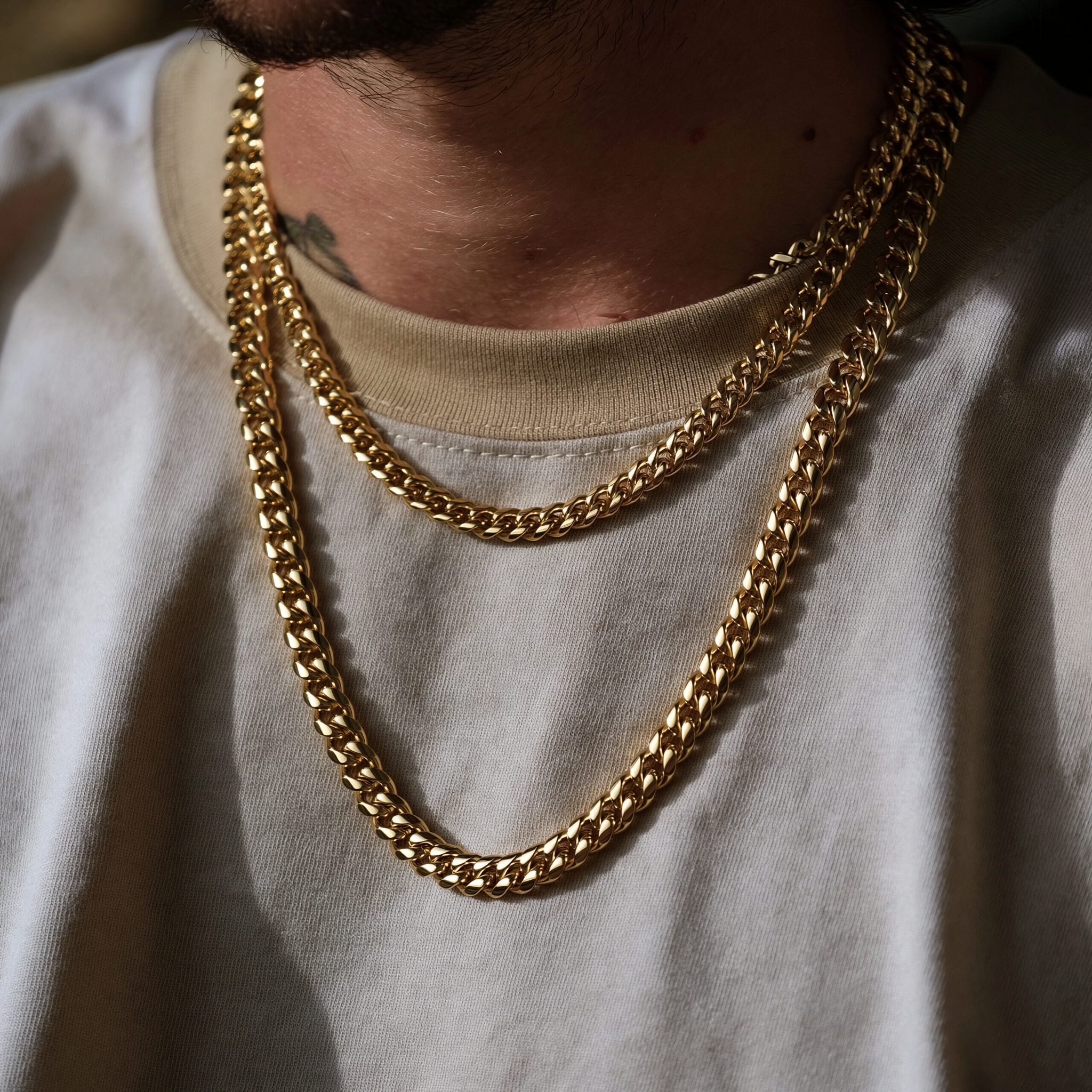 Gold layered chains on white shirt